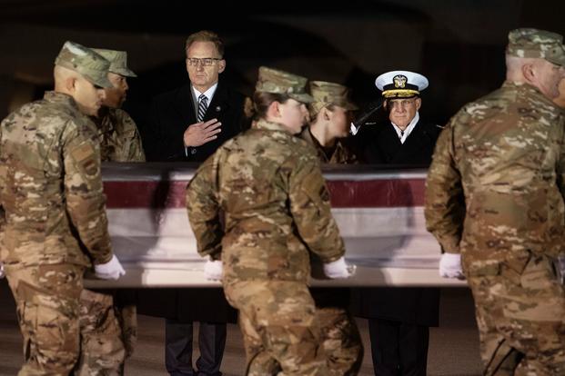 Acting Navy Secretary Thomas Modly, center, and Navy Adm. Michael Gilday, Chief of Naval Operations, look on as an Air Force carry team moves a transfer case containing the remains of Navy Seaman Mohammed Sameh Haitham, of St. Petersburg, Fla., Sunday, Dec. 8, 2019, at Dover Air Force Base, Del. A Saudi gunman killed three people including Haitham in a shooting at Naval Air Station Pensacola in Florida. (AP Photo/Cliff Owen)